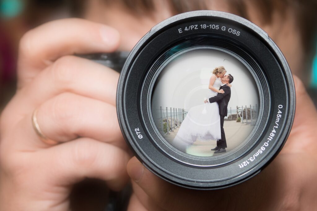 Wedding couple reflected in camera lens captured using cultural Indian wedding photography style