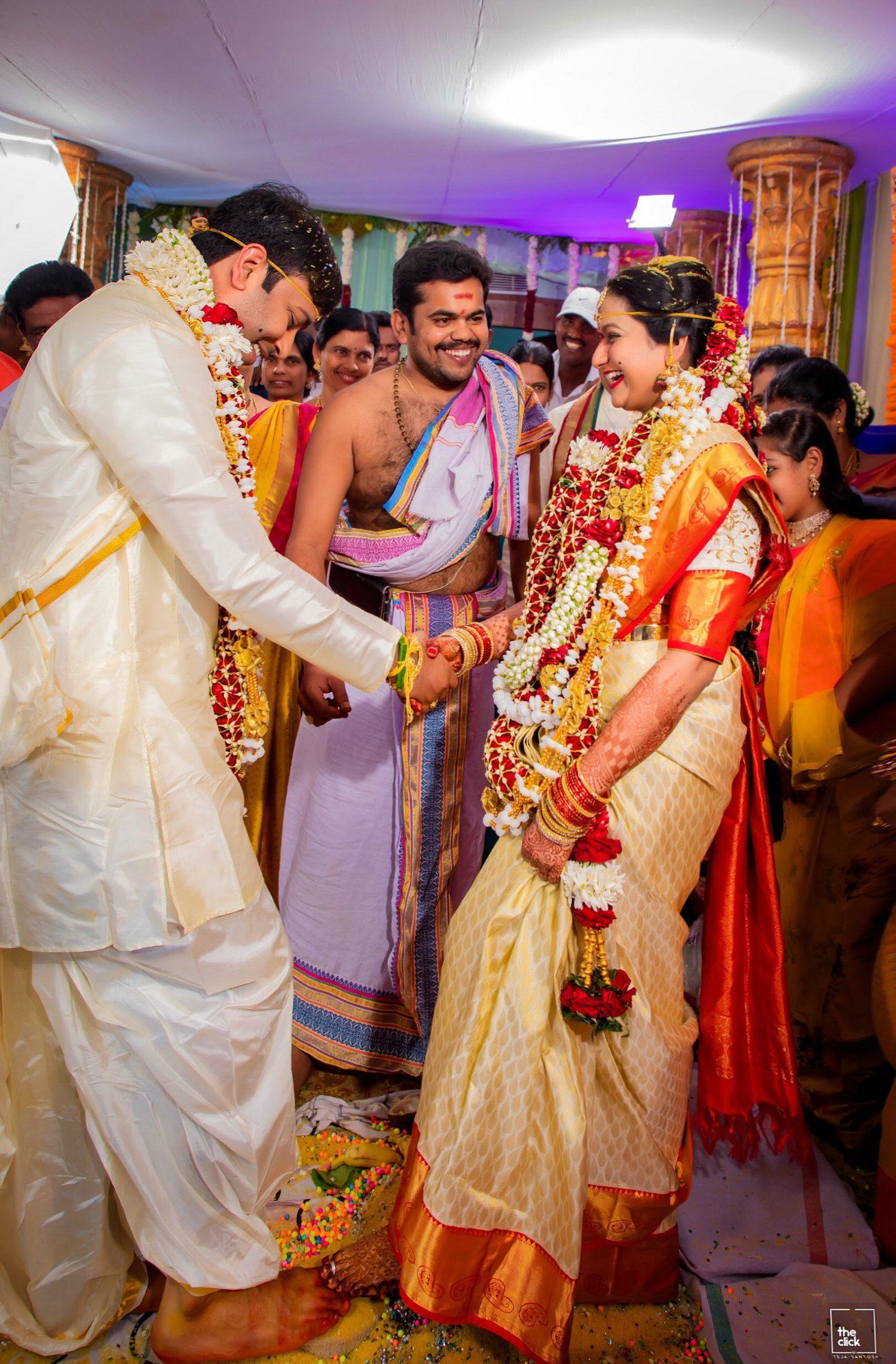 alt="Happy Telugu wedding couple holding hands during traditional ceremony in Hyderabad"