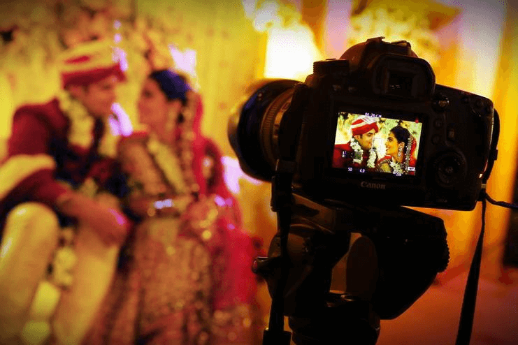 Wedding Photography Trends in Hyderabad Camera capturing an Indian wedding couple during a photoshoot, showcasing the work of professional wedding photographers in Hyderabad.